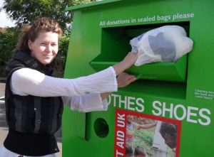 A young lady donating clothes to Planet Aid UK